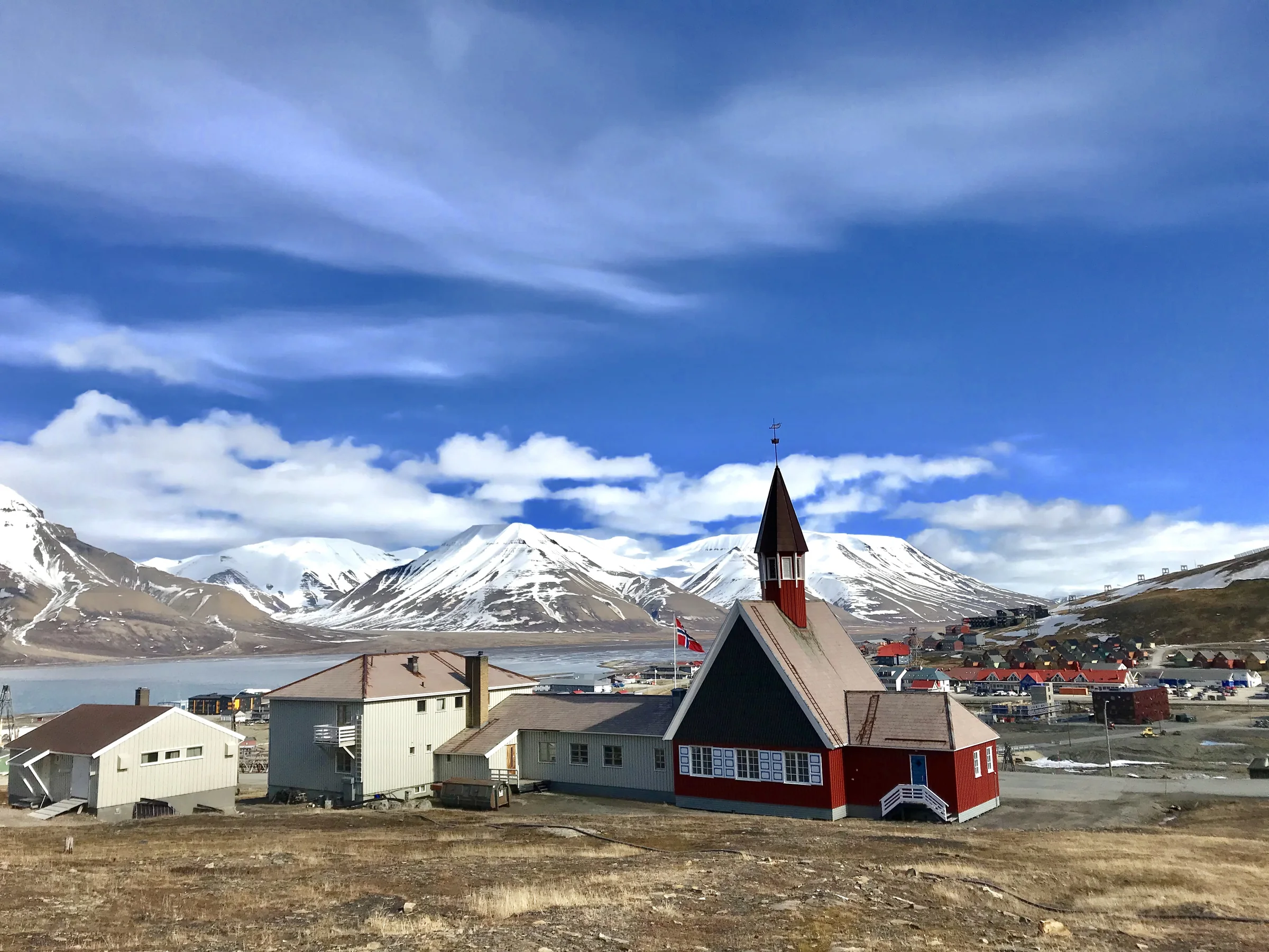 Svalbard Church beneath snow-covered mountains
