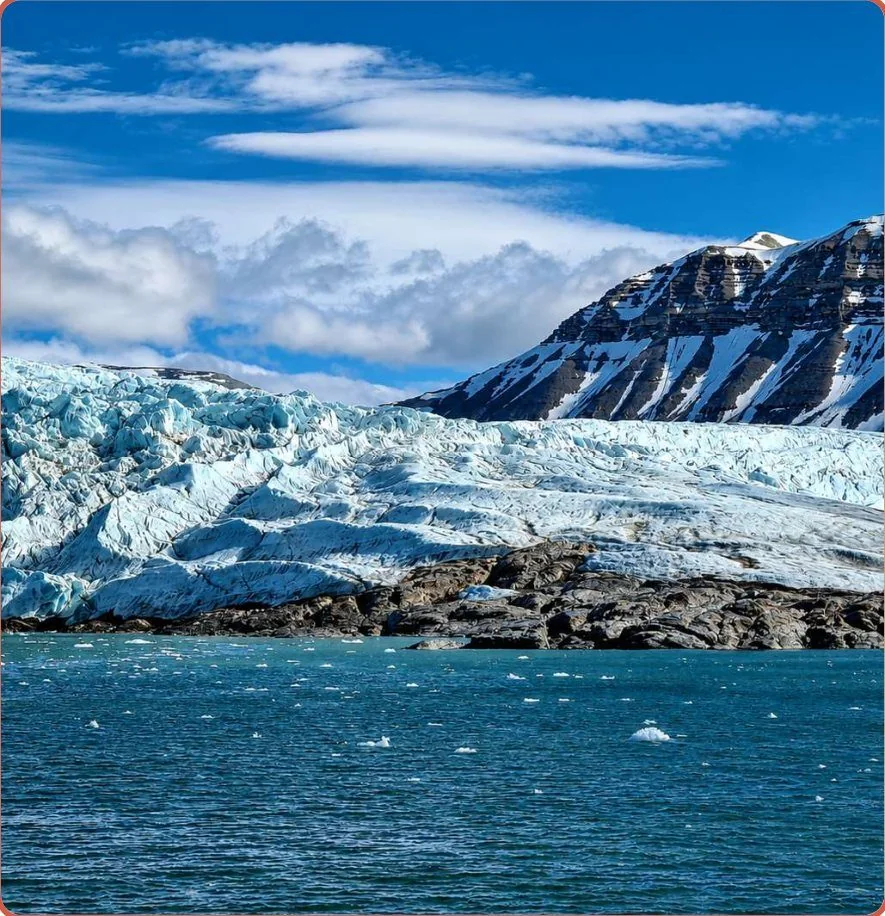 Glacier front meeting turquoise Arctic water in Svalbard