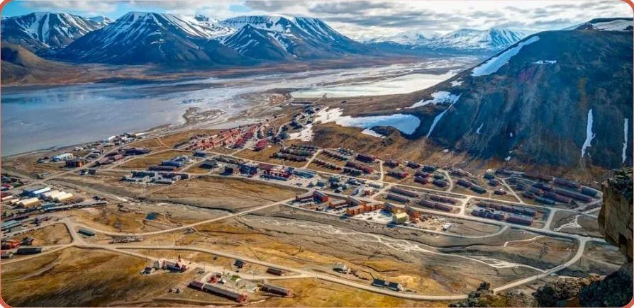 Aerial view of Longyearbyen between mountains and fjord